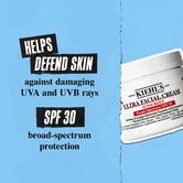 Teglica Ultra Facial Cream SPF 30 na plavoj pozadini sa tekstom: „Pomaže u odbrani kože od štetnih UVA i UVB zraka. SPF 30 zaštita širokog spektra.”