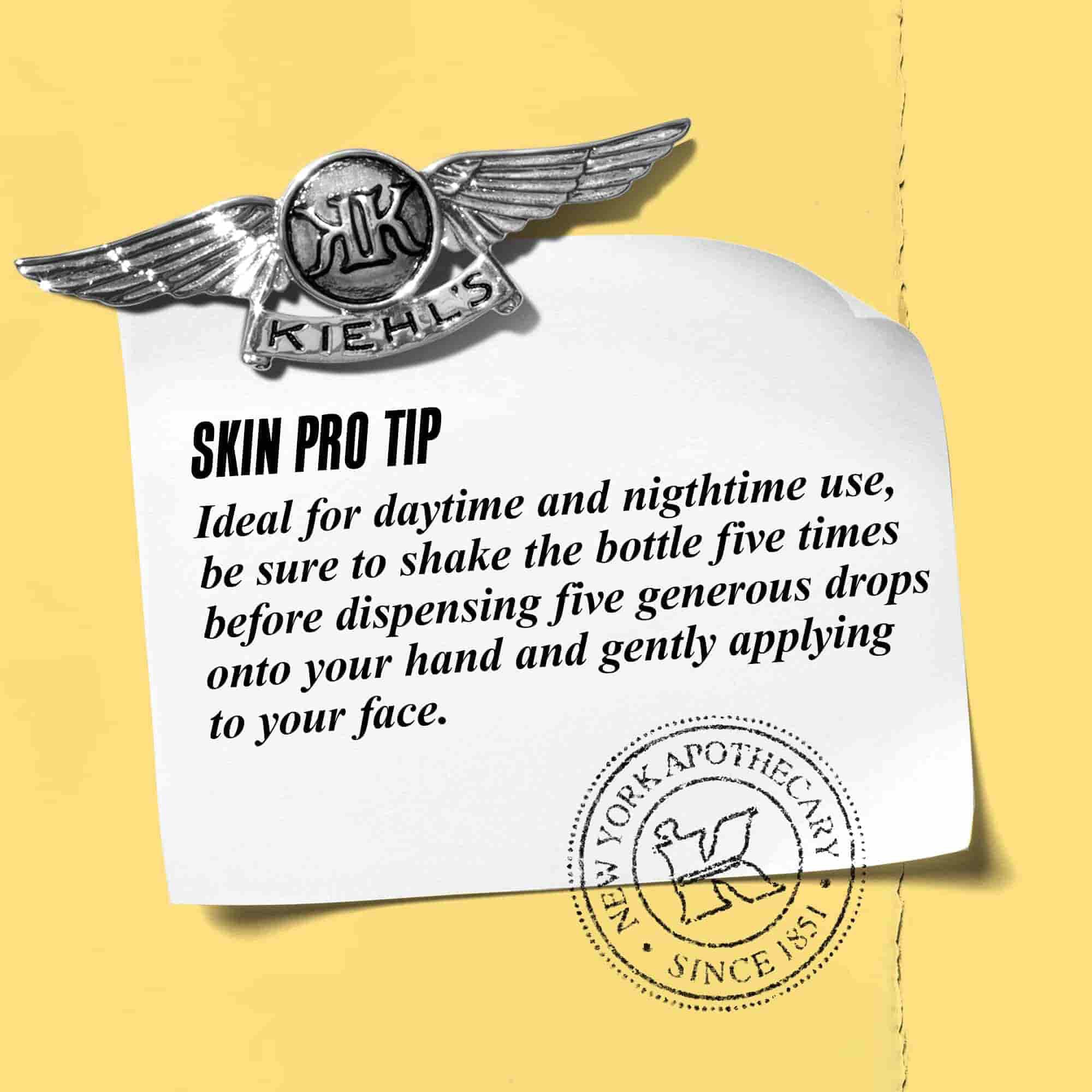 A graphic featuring a paper note with a Kiehl’s emblem. The note reads: "SKIN PRO TIP Ideal for daytime and nighttime use, be sure to shake the bottle five times before dispensing five generous drops onto your hand and gently applying to your face." 