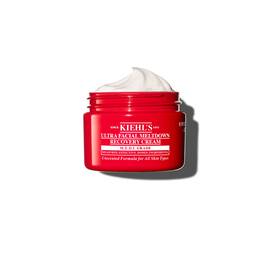 Crvena posudica kreme Kiehl’s Ultra Facial Meltdown Recovery Cream Whip, koja prikazuje vazdušastu teksturu.