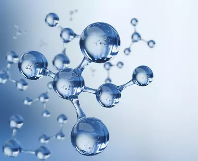 Close-up of transparent, spherical molecules against a soft blue background, illustrating a scientific or chemical concept.