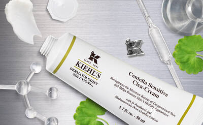 A tube of Kiehl's Centella Sensitive Cica-Cream, surrounded by cosmetic ingredients and lab equipment, emphasizing its dermatological benefits for sensitive skin.