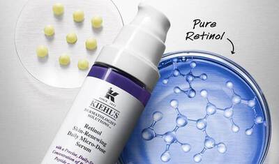 An image featuring a bottle of Kiehl's Retinol Skin-Renewing Daily Micro-Dose Serum next to a petri dish with yellow capsules and a blue background displaying molecular structures.